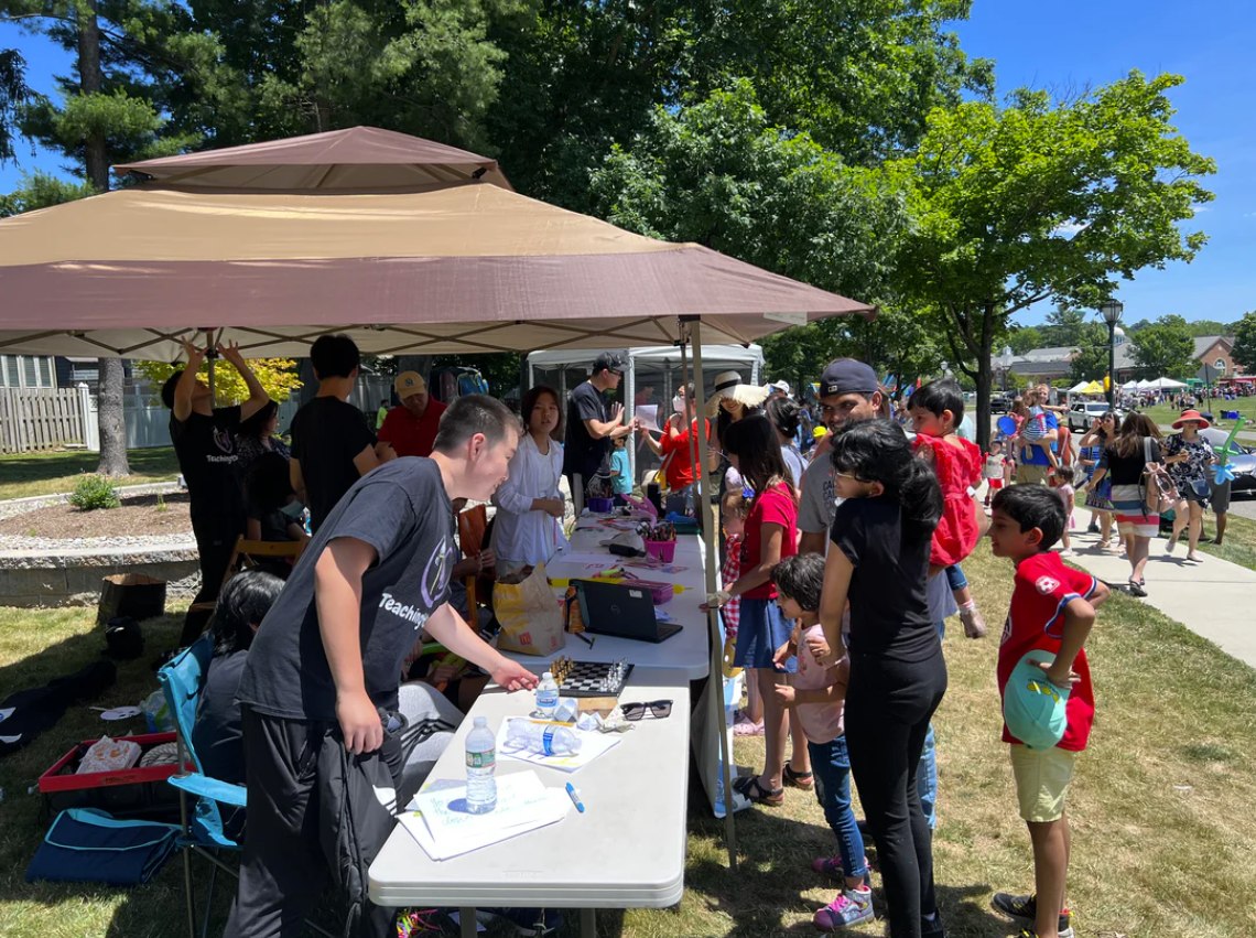Teaching 4 Charity volunteers leading community outreach activities at an outdoor event.